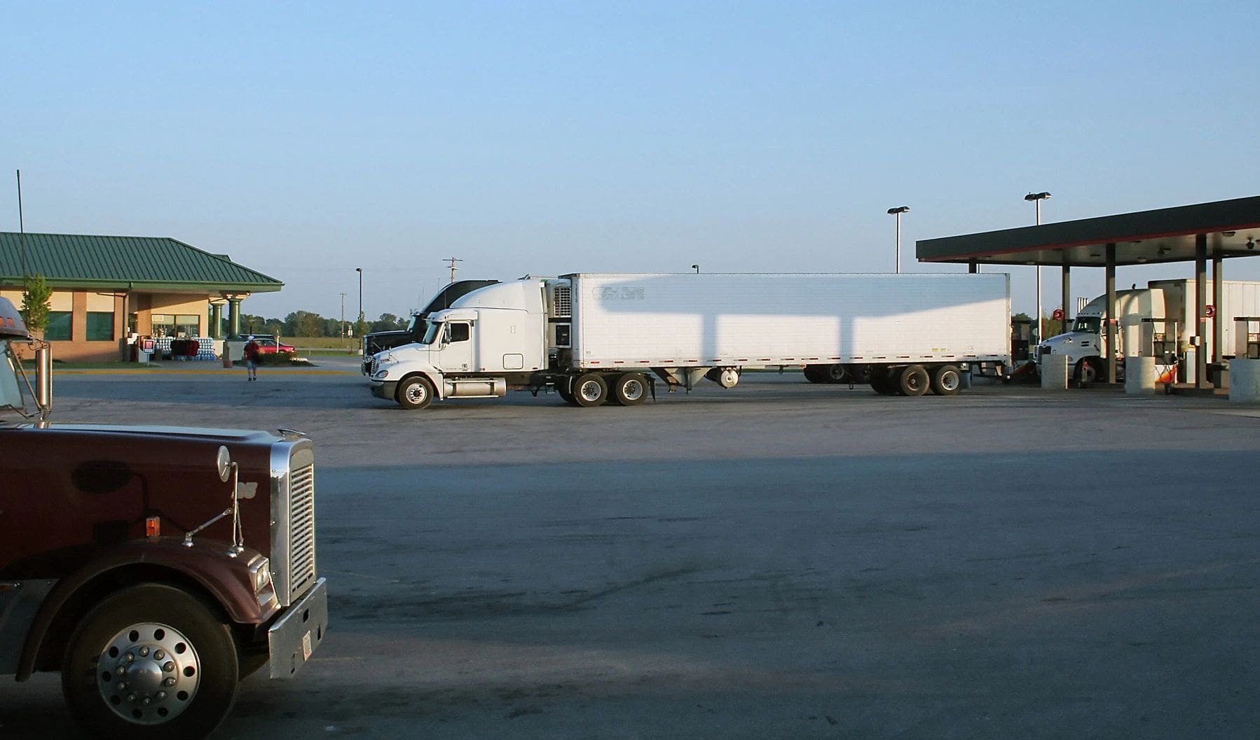 A white truck is parked in the parking lot.