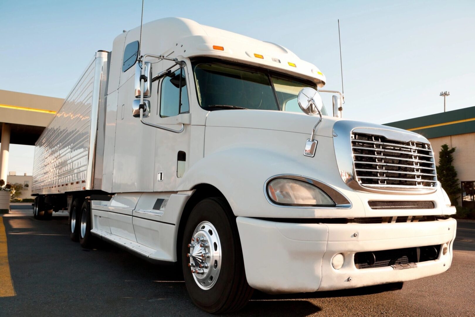 A white truck is parked on the side of the road.