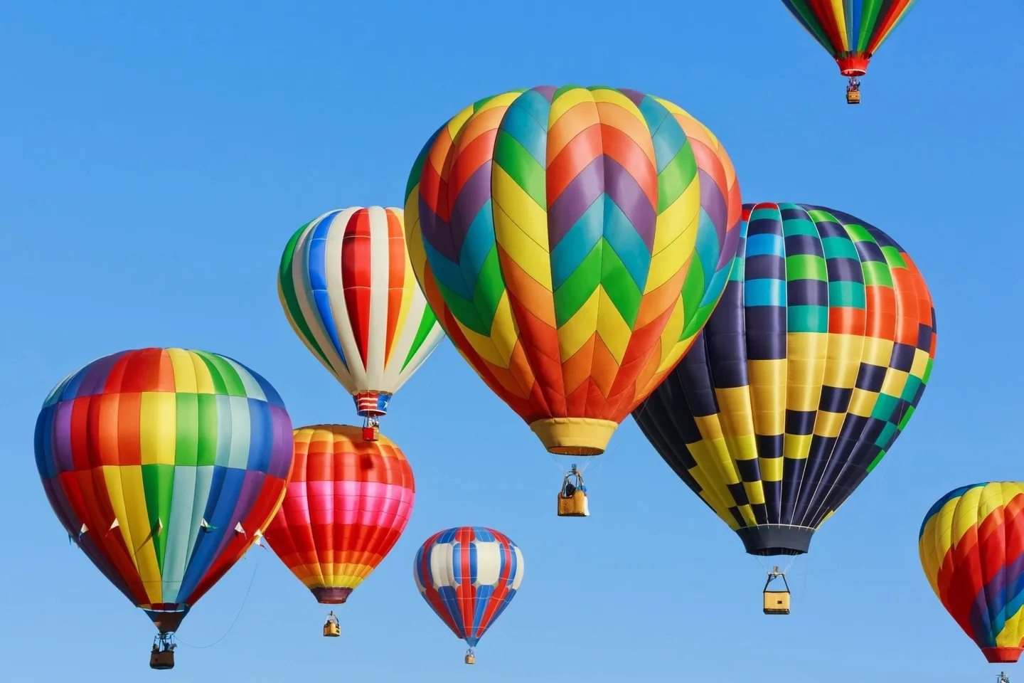 A group of hot air balloons flying in the sky.