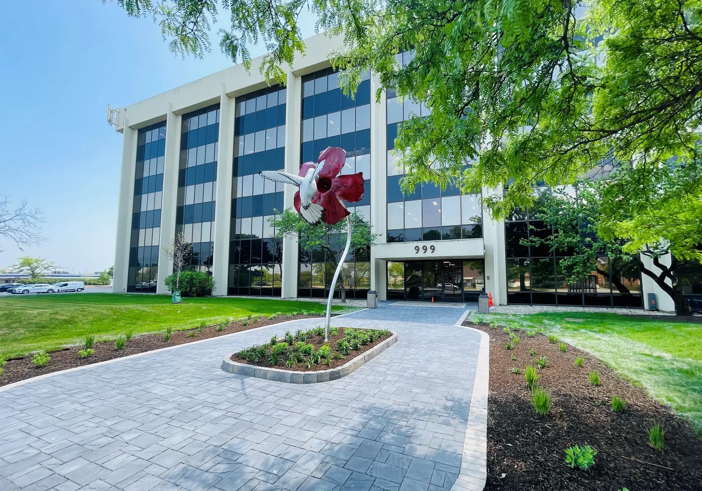 A large building with a flower sculpture in the middle of it.